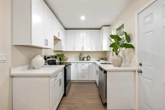 a kitchen with a sink stove and cabinets