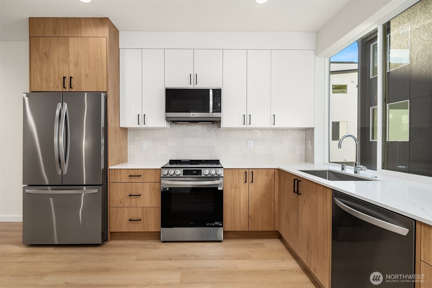 18017 2nd Avenue Northeast, Unit B Seattle, WA 98155 - Photo 3 of 19 a kitchen with stainless steel appliances granite countertop a refrigerator stove and sink