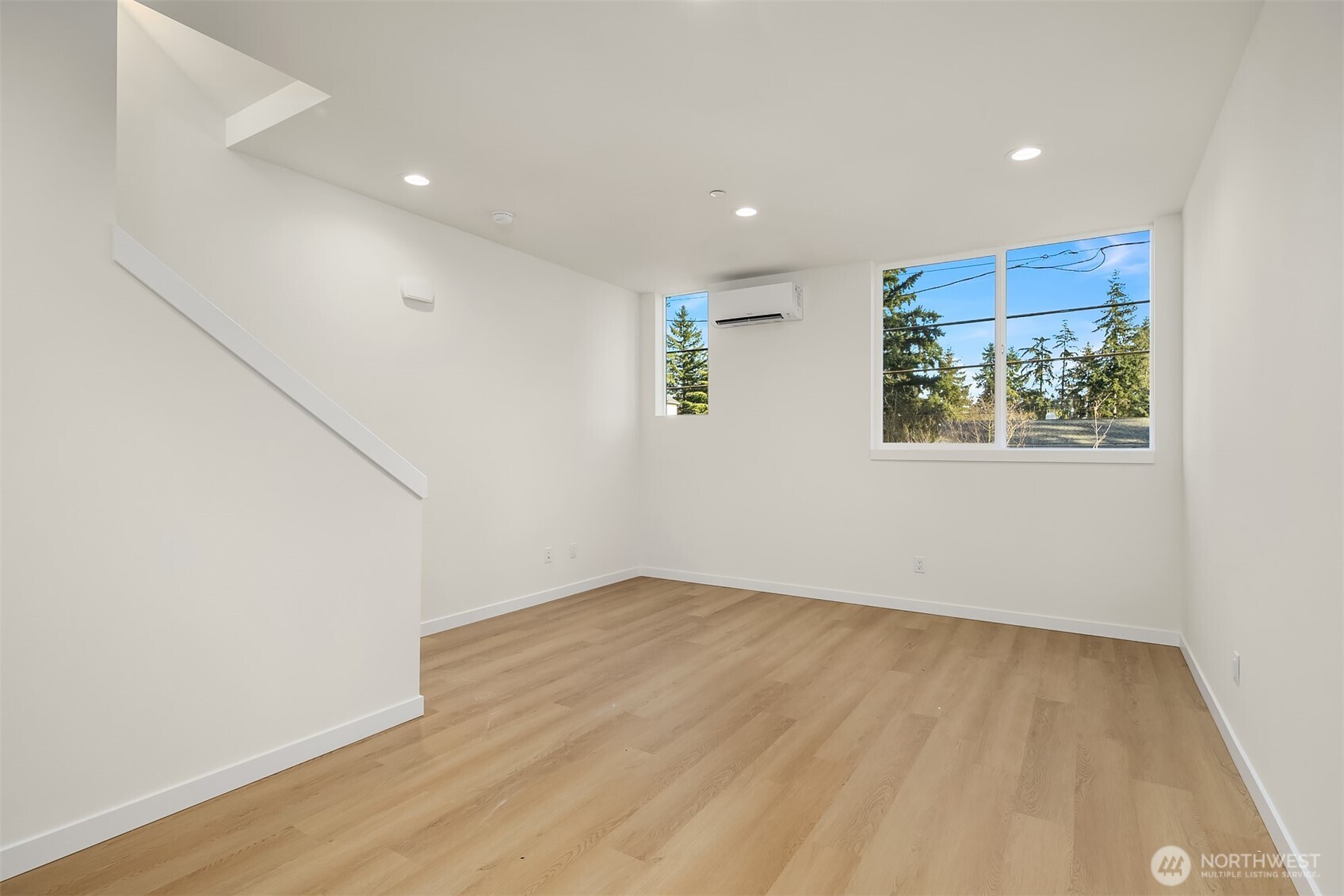 18017 2nd Avenue Northeast, Unit B Seattle, WA 98155 - Photo 7 of 19 an empty room with wooden floor and window