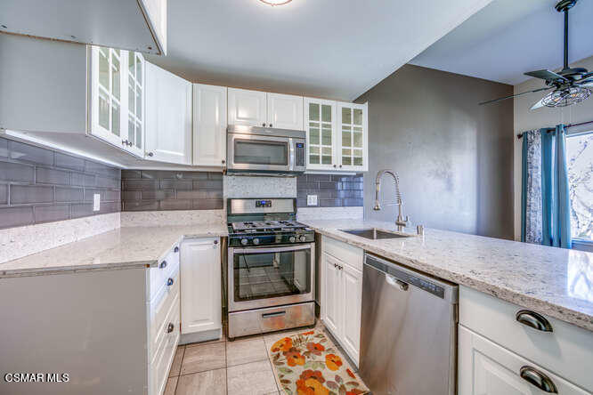 1766 Sinaloa Road, Unit 279 Simi Valley, CA 93065 - Photo 11 of 23 a kitchen with stainless steel appliances granite countertop a sink stove and refrigerator