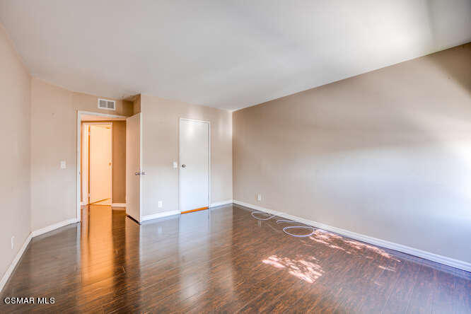 1766 Sinaloa Road, Unit 279 Simi Valley, CA 93065 - Photo 16 of 23 a view of empty room with wooden floor and window