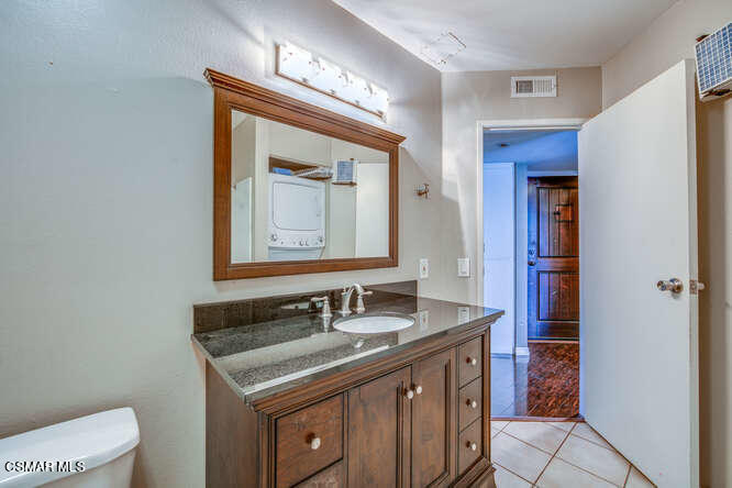 1766 Sinaloa Road, Unit 279 Simi Valley, CA 93065 - Photo 17 of 23 a bathroom with a granite countertop sink and a mirror