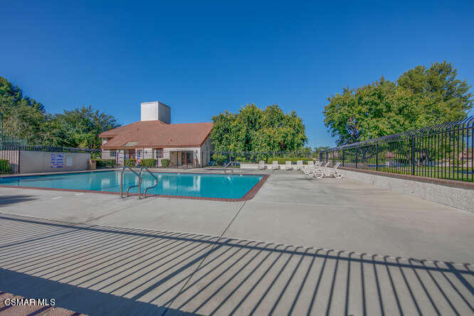 1766 Sinaloa Road, Unit 279 Simi Valley, CA 93065 - Photo 21 of 23 a view of a patio with table and chairs with wooden fence
