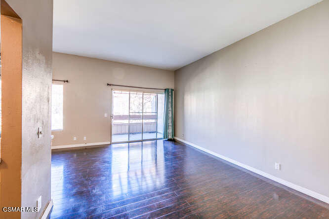 1766 Sinaloa Road, Unit 279 Simi Valley, CA 93065 - Photo 7 of 23 a view of an empty room with wooden floor and a window