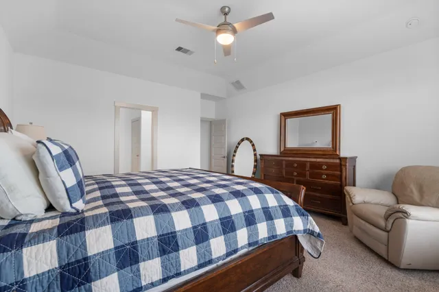 a bedroom with a bed a couch and dresser