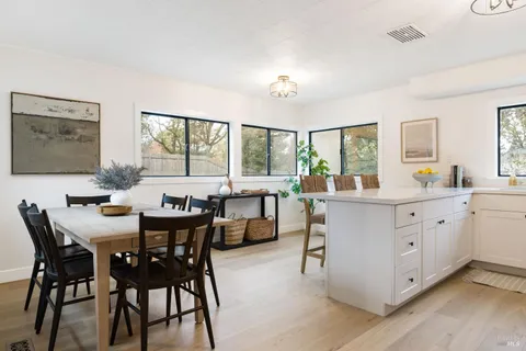 a view of a dining room with furniture and a large window