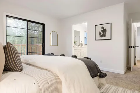 a bedroom with a bed and a large window