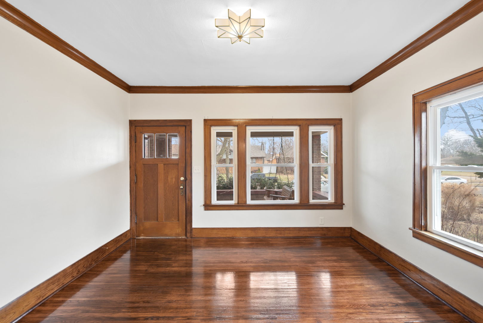 1065 South Poplar Avenue Kankakee, IL 60901 - Photo 3 of 17 a view of an empty room with wooden floor and a window