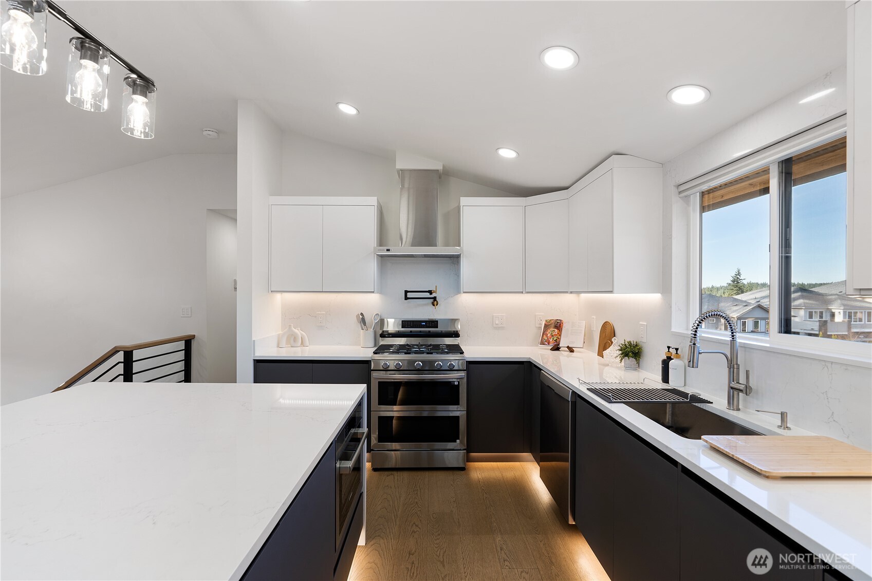 4215 228th Street Southeast Bothell, WA 98021 - Photo 13 of 36 a kitchen with stainless steel appliances a sink stove and cabinets