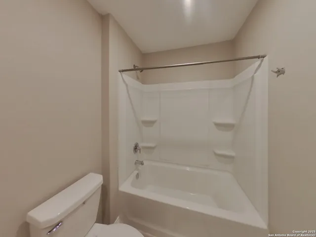 a bathroom with a shower and toilet