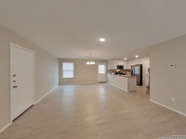 a view of a kitchen with a sink and cabinets