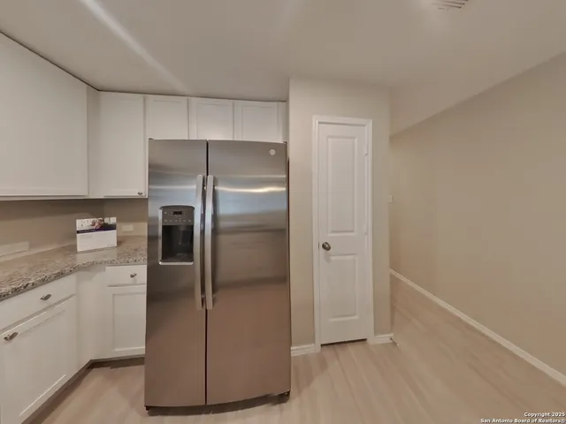 a kitchen with a refrigerator and a sink