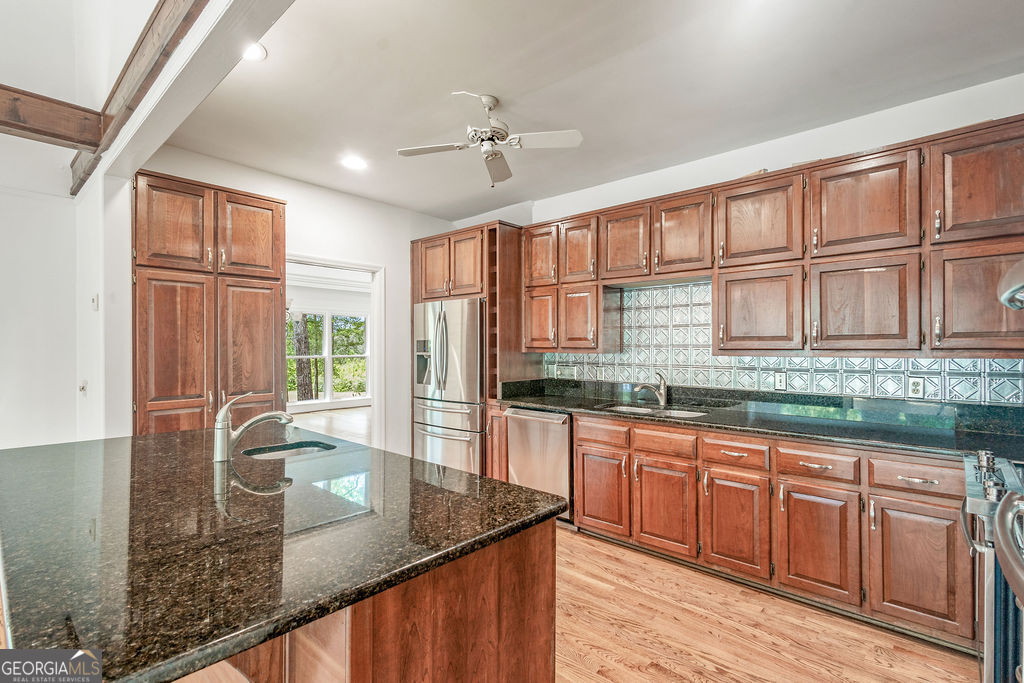 230 Haynes Road Moreland, GA 30259 - Photo 10 of 38 a kitchen with stainless steel appliances granite countertop a sink window and cabinets
