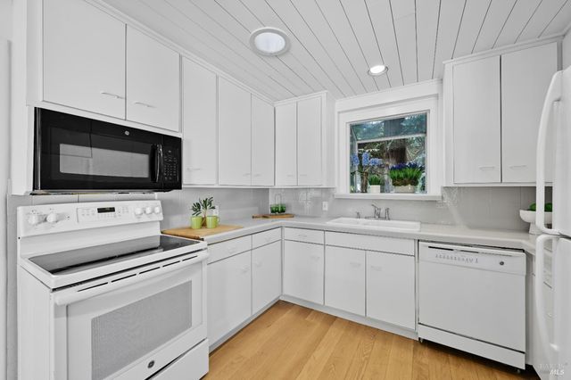 a kitchen with a sink and a stove top oven