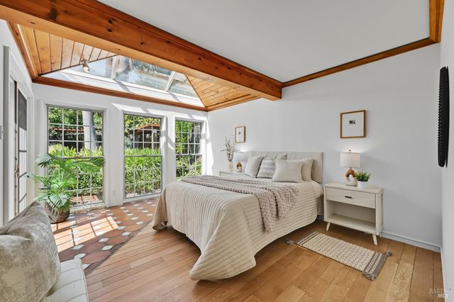 a spacious bedroom with a bed and a large window