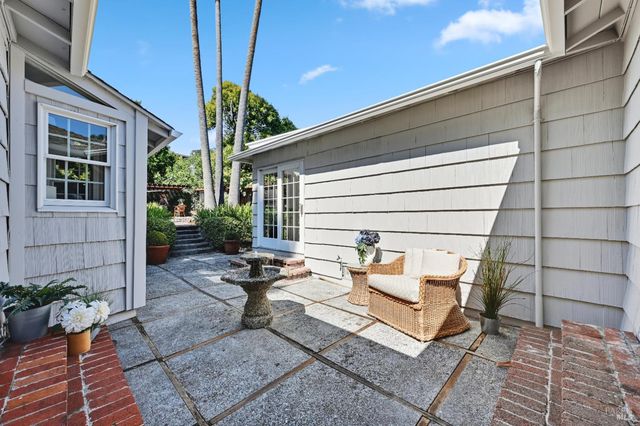a backyard of a house with outdoor seating