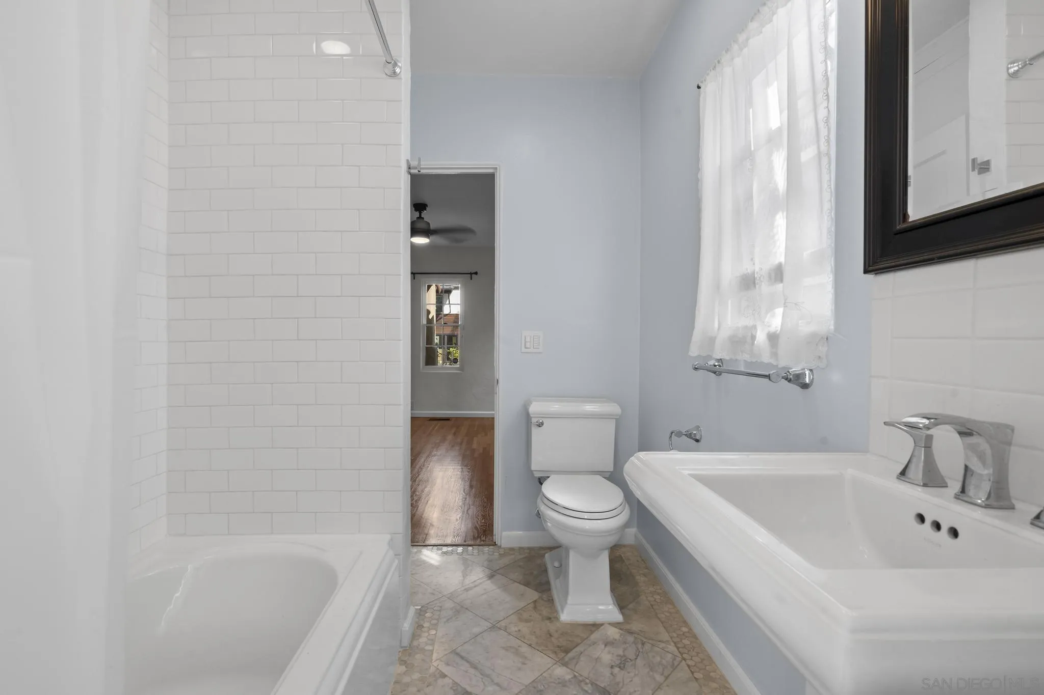 607 Arenas Street La Jolla, CA 92037 - Photo 14 of 37 a bathroom with a toilet a sink and bathtub