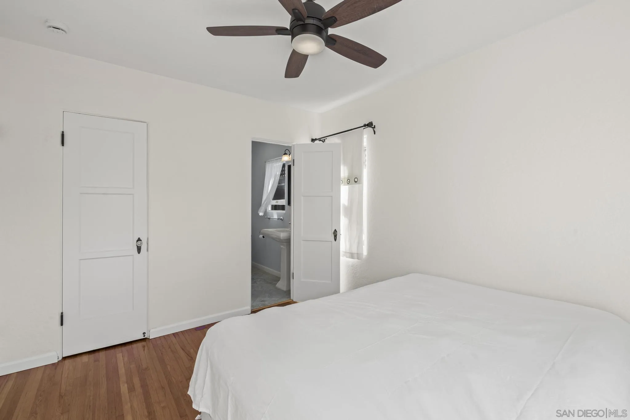 607 Arenas Street La Jolla, CA 92037 - Photo 16 of 37 a bedroom with a bed and a ceiling fan