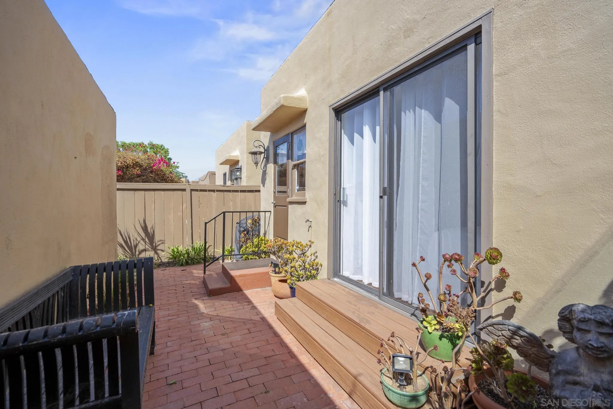 607 Arenas Street La Jolla, CA 92037 - Photo 21 of 37 a balcony with potted plants and wooden fence