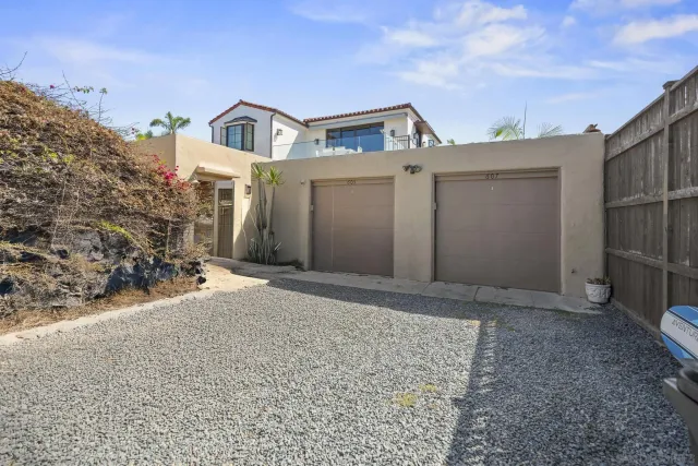 a front view of a house with parking space