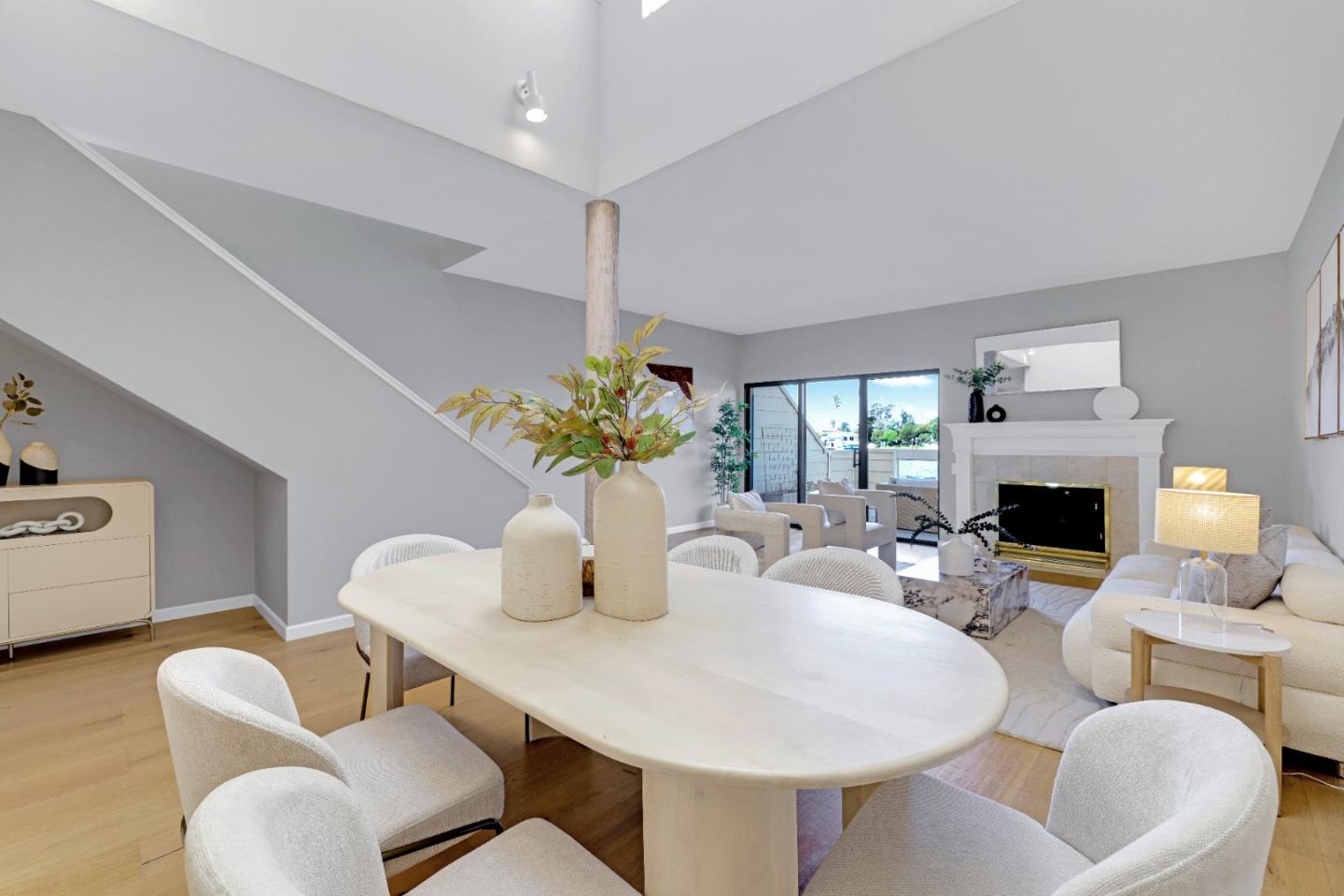 972 Shoreline Drive San Mateo, CA 94404 - Photo 13 of 64 a dining room with furniture a fireplace and wooden floor