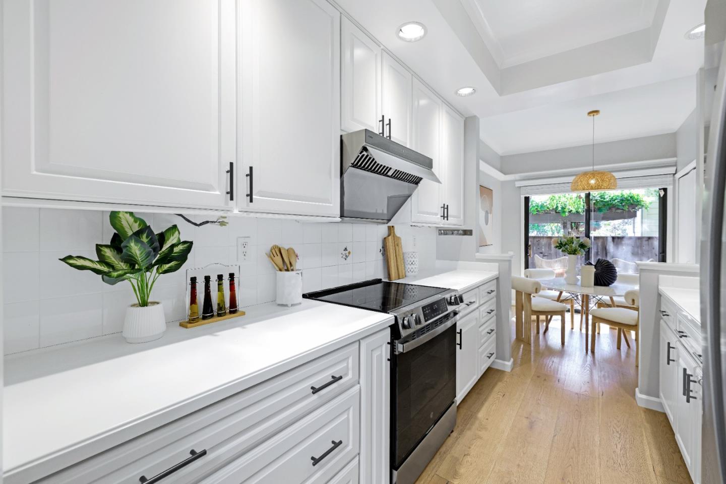 972 Shoreline Drive San Mateo, CA 94404 - Photo 15 of 64 a kitchen with granite countertop a sink a stove and cabinets