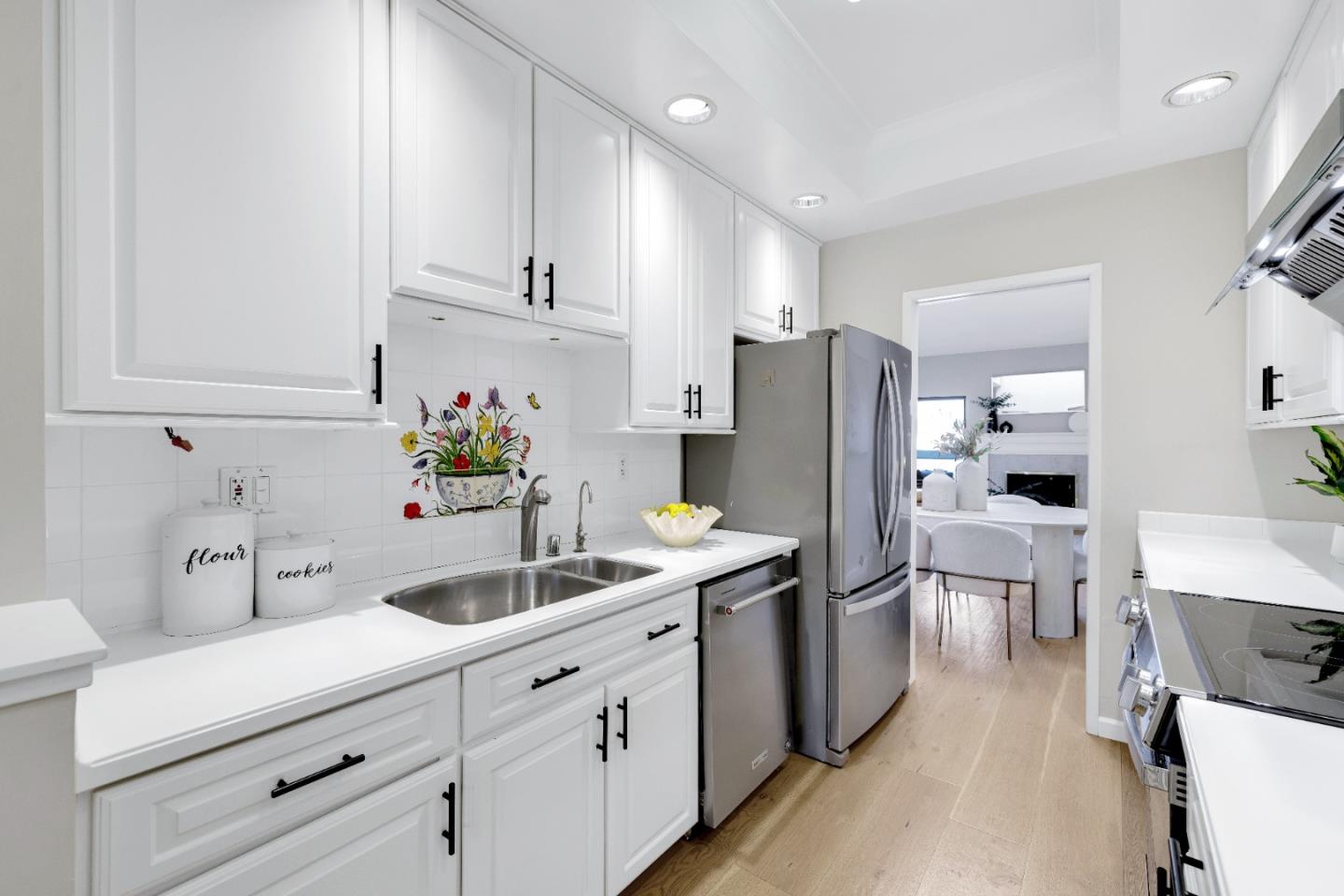 972 Shoreline Drive San Mateo, CA 94404 - Photo 16 of 64 a kitchen with white cabinets and stainless steel appliances