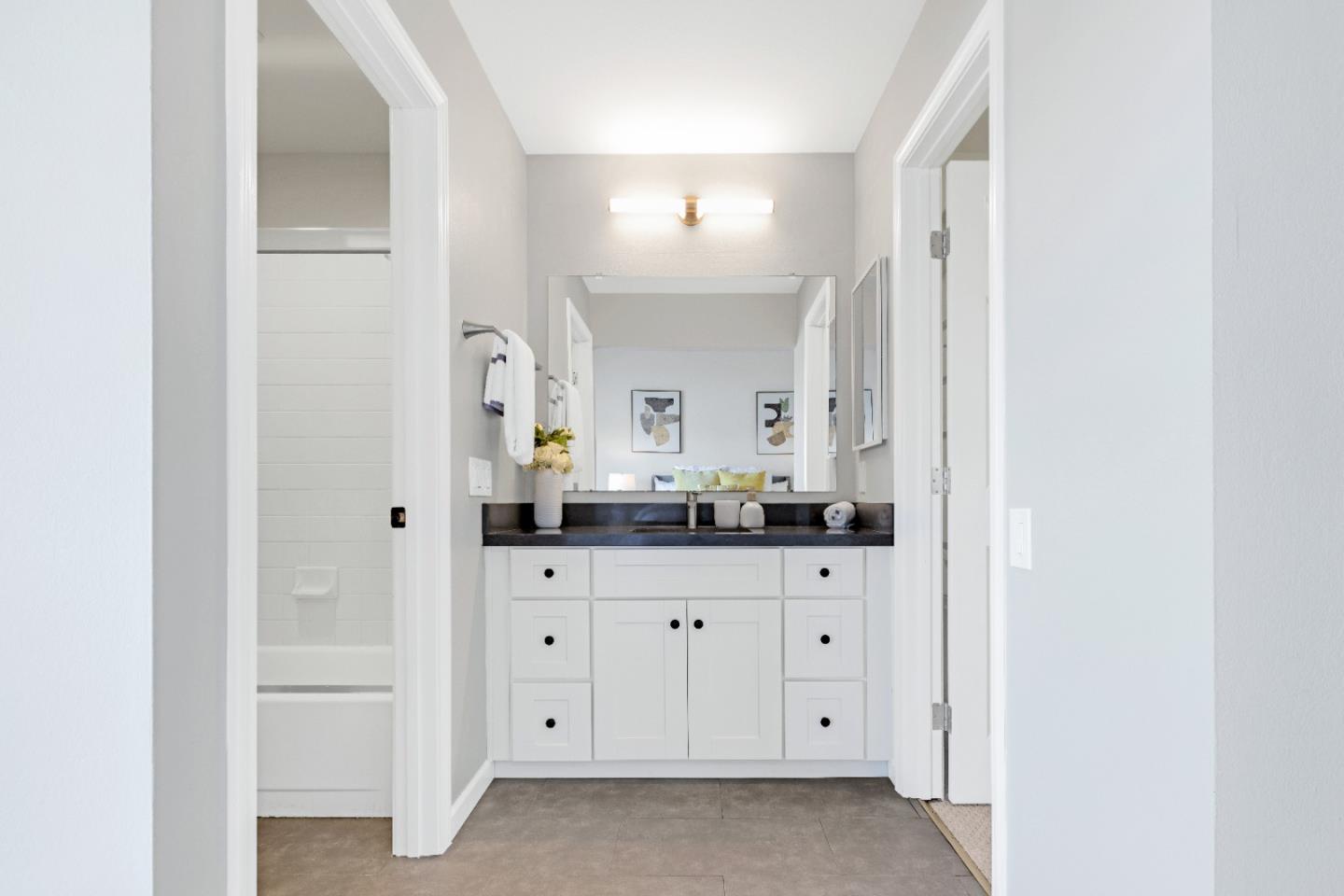 972 Shoreline Drive San Mateo, CA 94404 - Photo 33 of 64 a bathroom with a granite countertop sink and a mirror