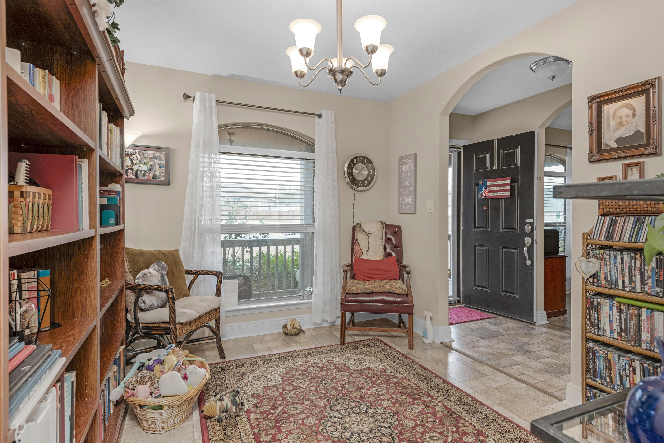 1680 Twin Pines Circle Cantonment, FL 32533 - Photo 14 of 39 a living room with fireplace furniture and a book shelf