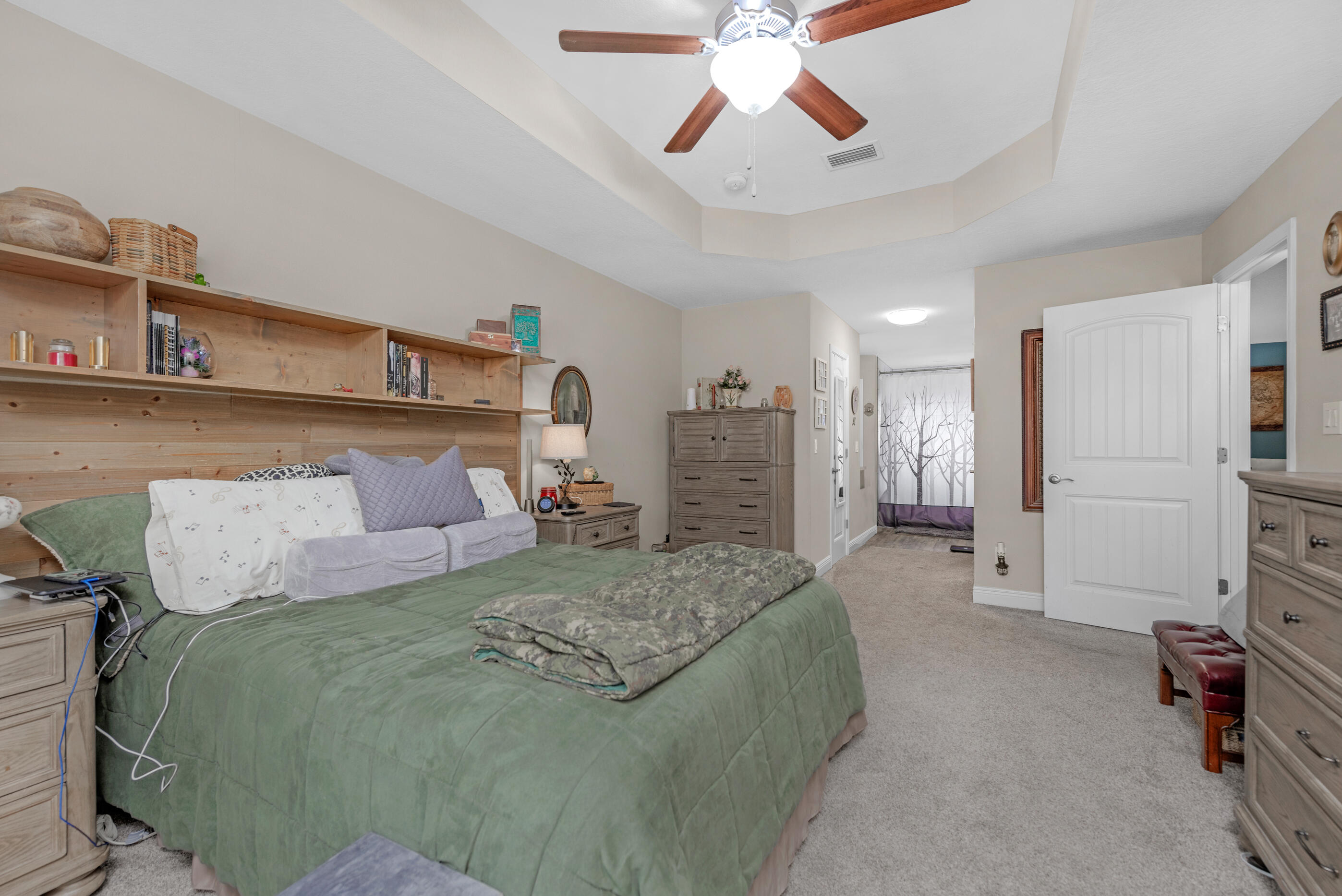 1680 Twin Pines Circle Cantonment, FL 32533 - Photo 30 of 39 a spacious bedroom with a bed and a chandelier