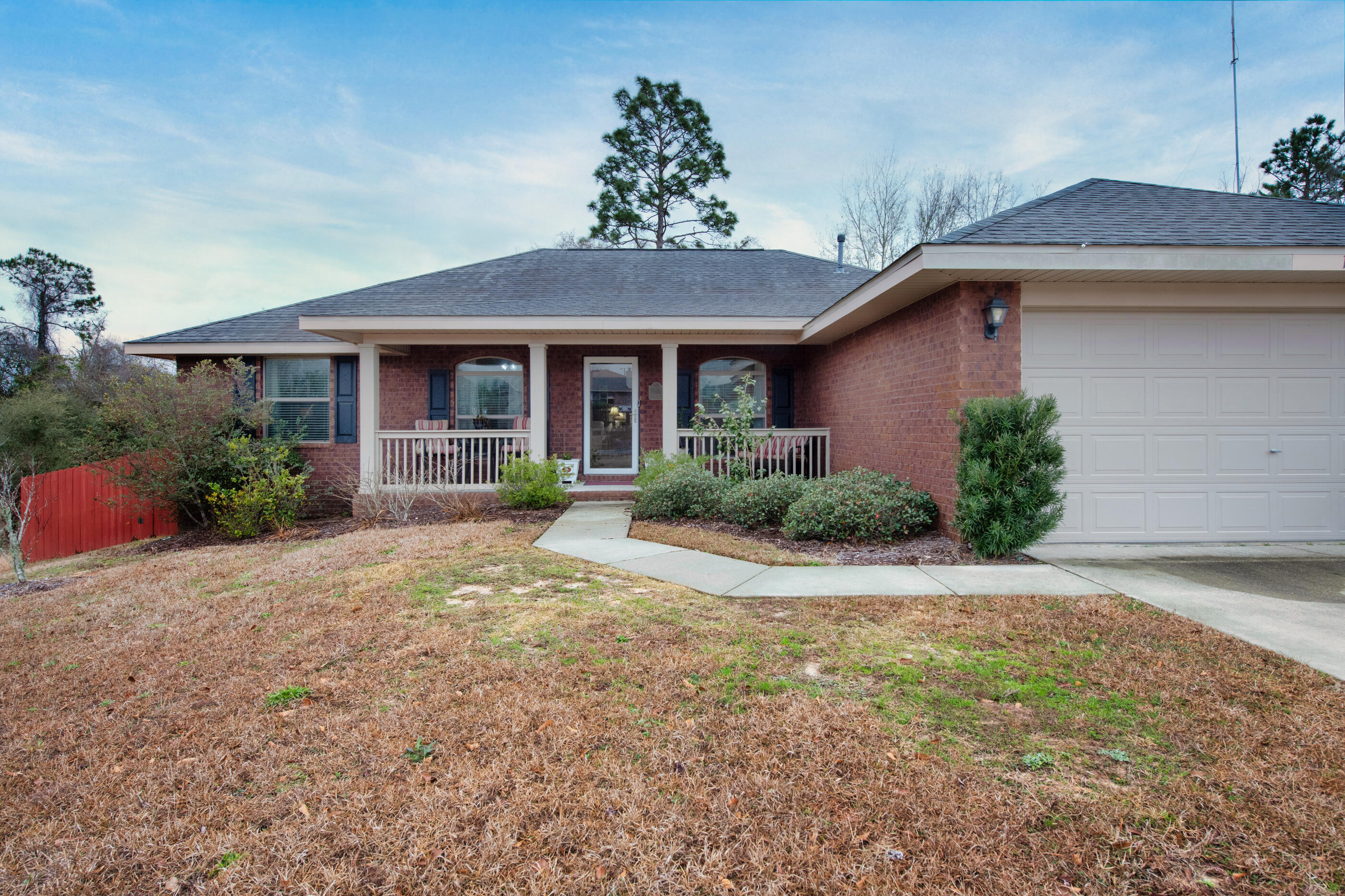 1680 Twin Pines Circle Cantonment, FL 32533 - Photo 3 of 39 a front view of a house with a yard