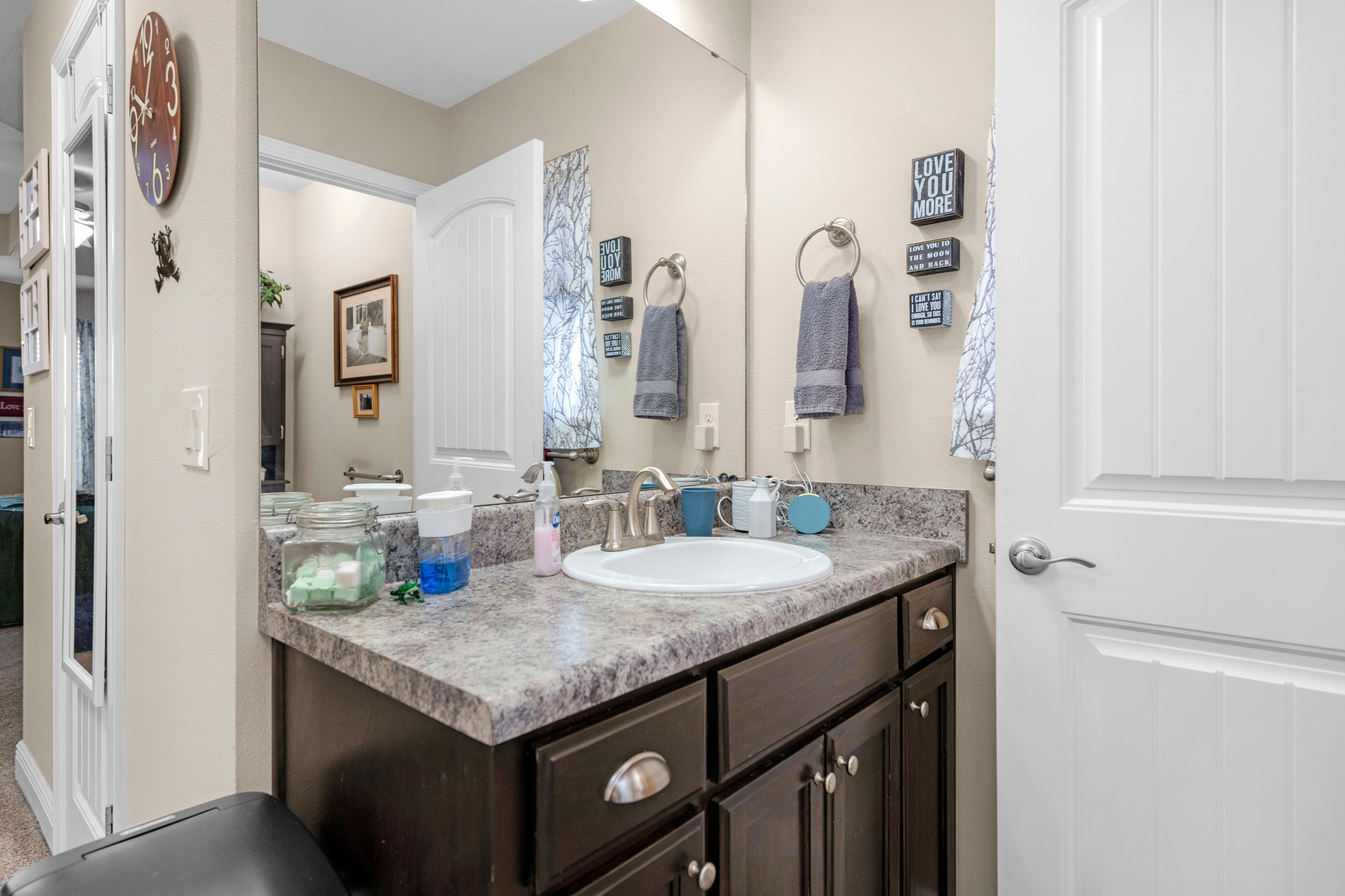 1680 Twin Pines Circle Cantonment, FL 32533 - Photo 32 of 39 a bathroom with a granite countertop sink and a mirror