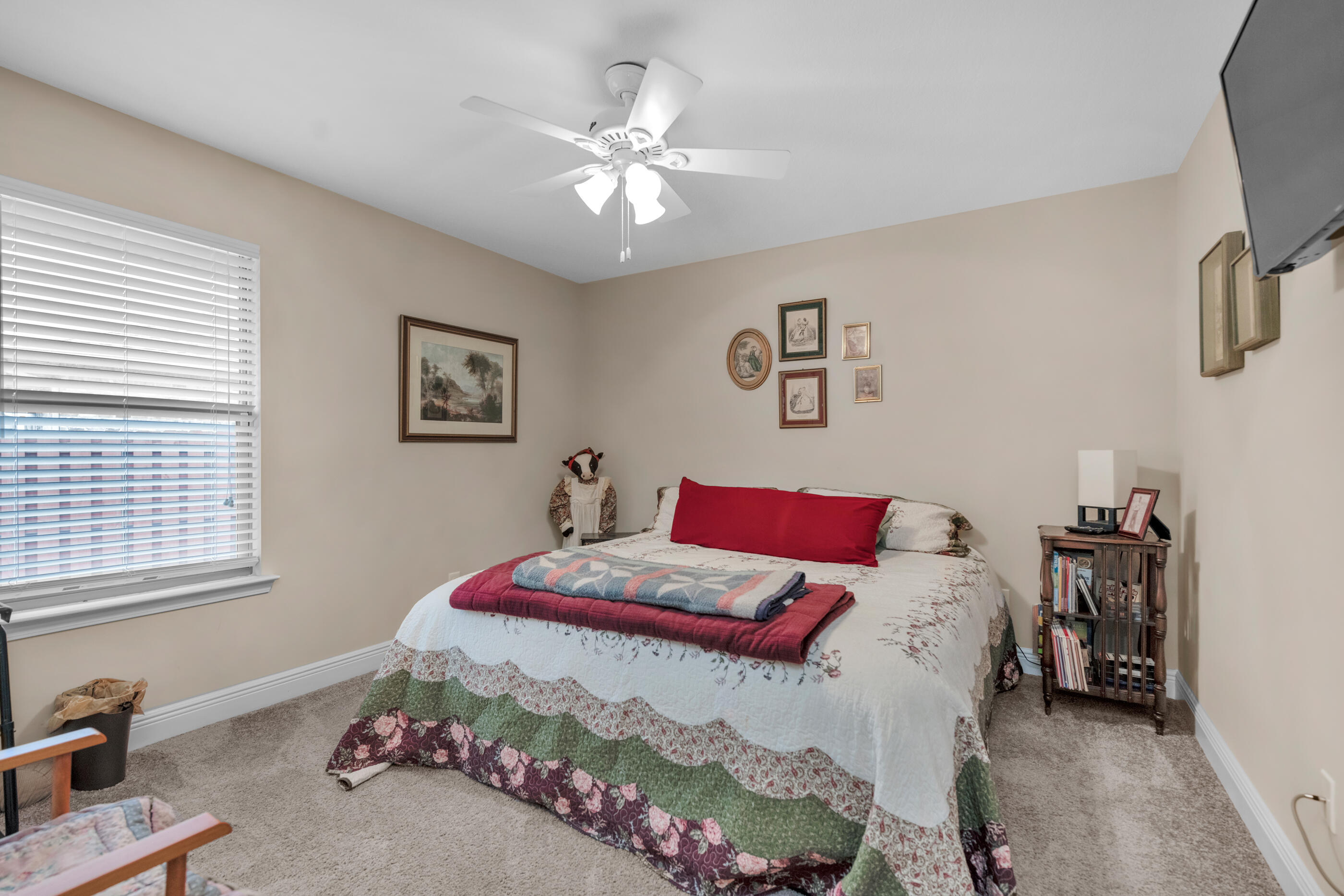 1680 Twin Pines Circle Cantonment, FL 32533 - Photo 36 of 39 a bedroom with a bed and a chandelier
