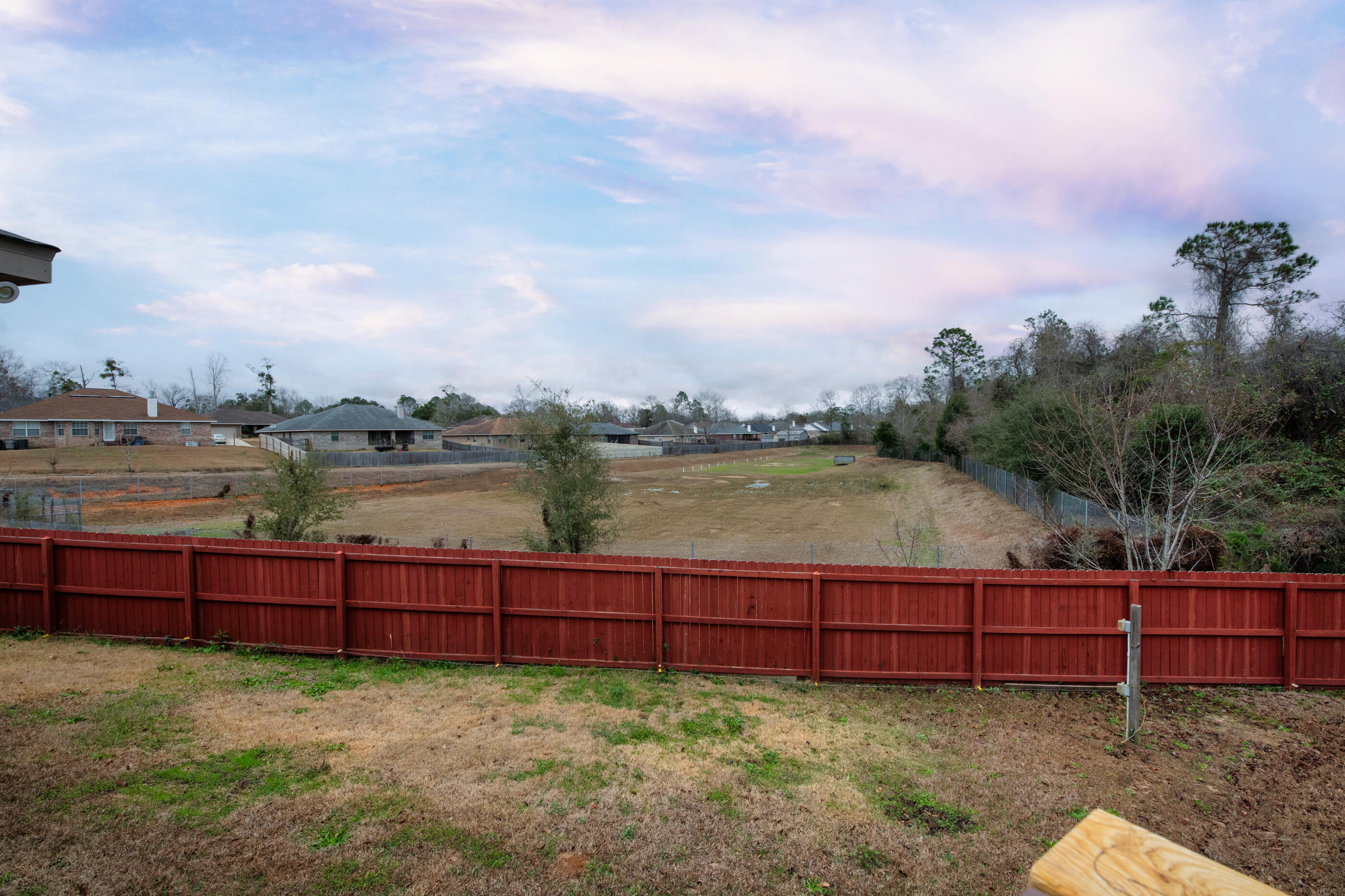 1680 Twin Pines Circle Cantonment, FL 32533 - Photo 8 of 39 a view of a yard with lake and houses in the back