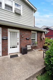 a view of an house with backyard and a garage