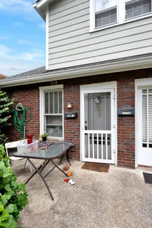 a backyard of a house with seating space and barbeque grill