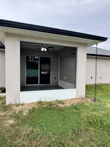 a view of yard with swimming pool and trees in the background