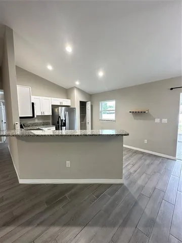 a view of kitchen living room with wooden floor and window
