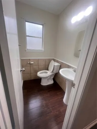 a bathroom with a sink toilet a mirror and vanity
