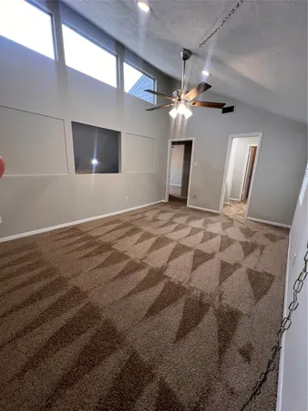 a view of a livingroom with a ceiling fan and window
