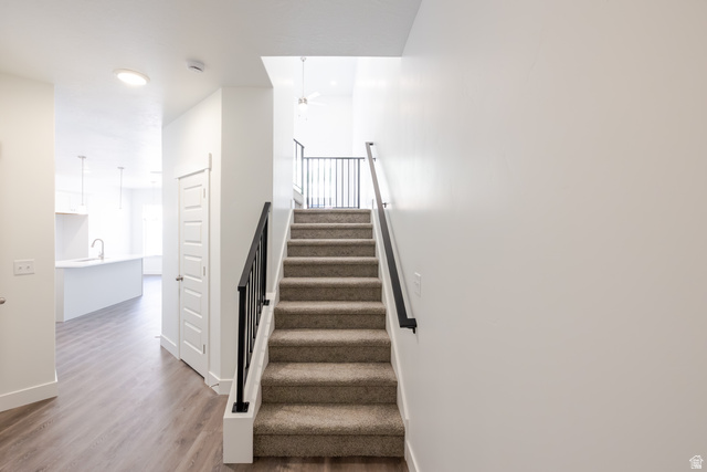 5287 South Acacia Drive, Unit 714 Mapleton, UT 84664 - Photo 13 of 21 Carpeted staircase with black wrought iron railing