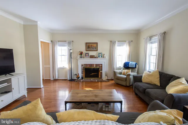 a living room with furniture fireplace and window