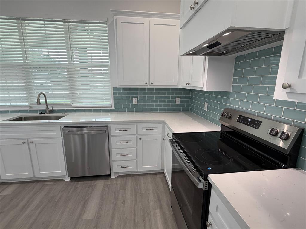 4200 Williams Road Bellmead, TX 76705 - Photo 9 of 22 a kitchen with a sink stove and cabinets