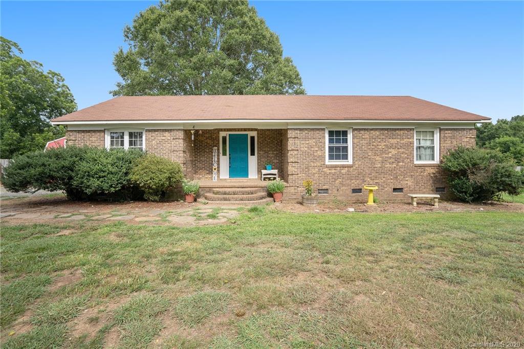 1714 East Sandy Ridge Road Monroe, NC 28112 - Photo 1 of 28 a backyard of a house with table and chairs