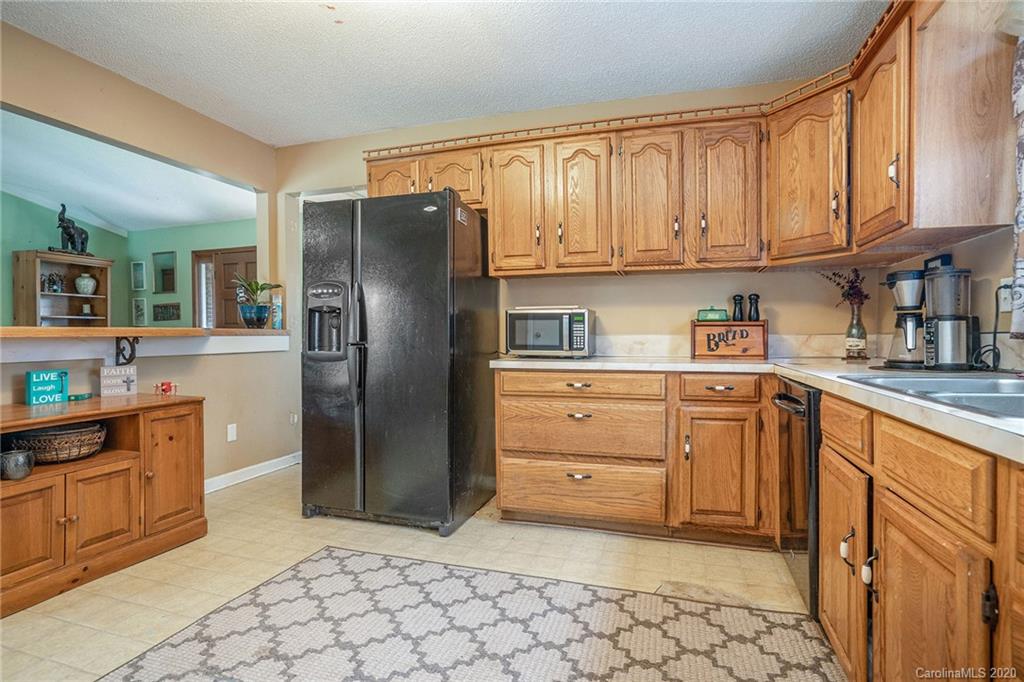1714 East Sandy Ridge Road Monroe, NC 28112 - Photo 13 of 28 a kitchen with stainless steel appliances granite countertop a refrigerator and cabinets