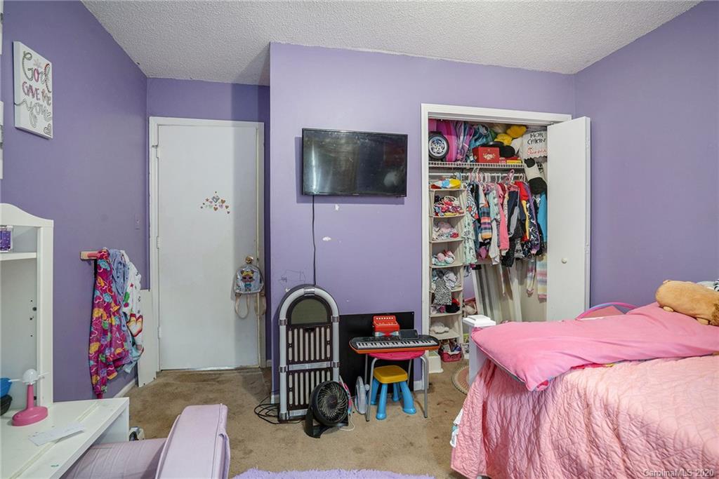 1714 East Sandy Ridge Road Monroe, NC 28112 - Photo 18 of 28 a bedroom with a bed and a flat screen tv