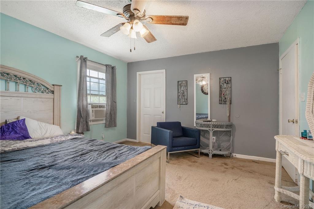 1714 East Sandy Ridge Road Monroe, NC 28112 - Photo 21 of 28 a bedroom with a bed a desk and chair