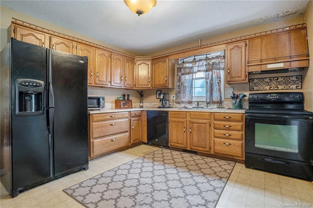 1714 East Sandy Ridge Road Monroe, NC 28112 - Photo 10 of 28 a kitchen with stainless steel appliances granite countertop a refrigerator sink and cabinets