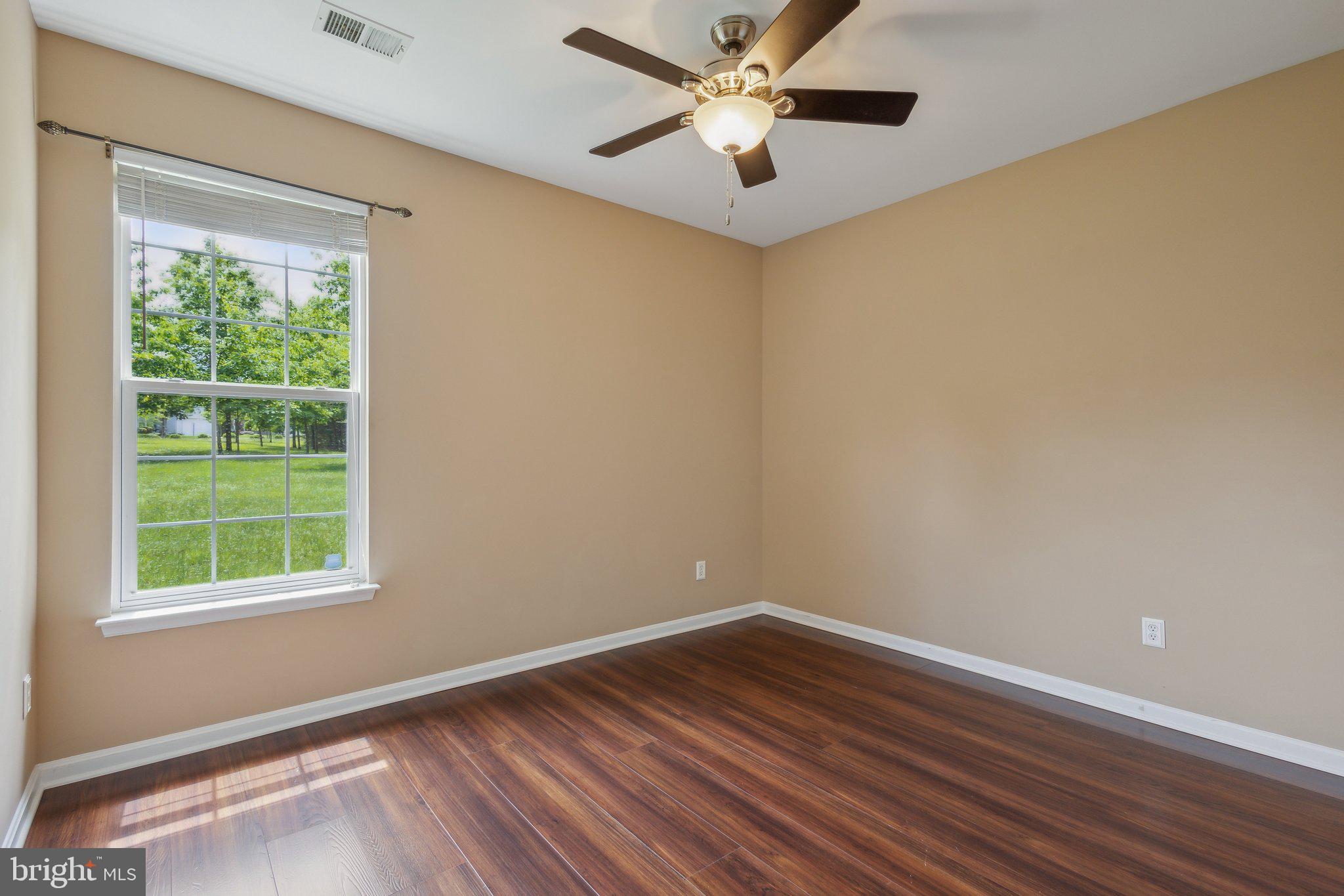 16100 Dancing Leaf Place Dumfries, VA 22025 - Photo 29 of 35 wooden floor in an empty room with a window
