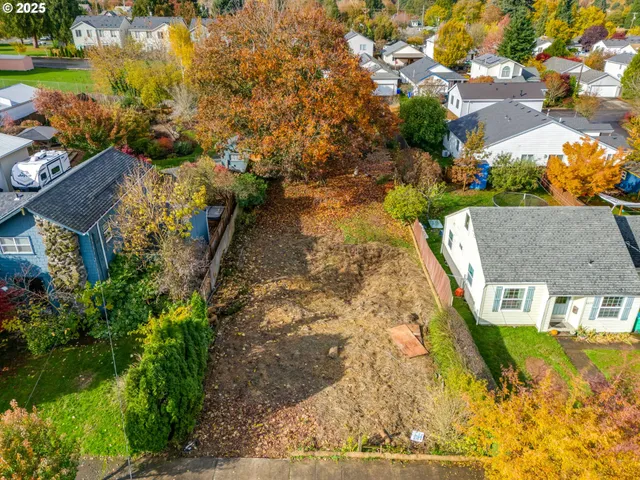 an aerial view of residential houses with yard
